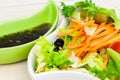 Vegetable salads with sauce on table