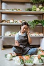 Vegetable seller wearing apron calling using a phone