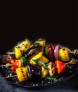 Vegetable skewers with Greek or Italian dressing on dark background . Grilled Vegetables ar gourmet vegan food. Close-up