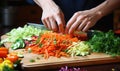 A vegetable slicer in action slicing cucumbers and tomatoes