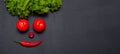 Vegetable smiling face. Fresh organic Vegetables on dark table. Healthy Vegetarian food, View from above Royalty Free Stock Photo