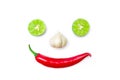Vegetable smiling face from red chili pepper , garlic and lime on white background