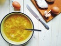 vegetable soup, bread and butter, eggs, a cup of tea and garlic on the table Royalty Free Stock Photo