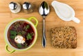 Vegetable soup, bread, salt, pepper and sour cream on table Royalty Free Stock Photo