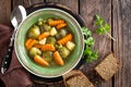 Vegetable soup with brussel sprouts on wooden rustic table Royalty Free Stock Photo