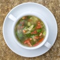 Vegetable soup with ingredients cauliflower, red tomato, green beans in white plate, top view Royalty Free Stock Photo