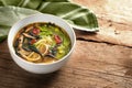 Vegetable soup with noodles, miso, nori seaweed, snow peas, ginger and chili in a bowl and a green kitchen towel on a rustic Royalty Free Stock Photo