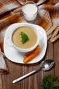 Vegetable soup with parsley and fried bread on a wooden table. Royalty Free Stock Photo