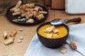 Vegetable soup puree of pumpkin, carrots and celery, served with croutons and pumpkin seeds. Rustic style