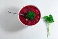 Vegetable soup - red borsch in a white bowl on a white wooden background, top view. Healthy beetroot soup, vegetarian food.. Royalty Free Stock Photo