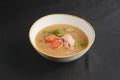 Vegetable soup with salmon in white bowl over black background. Dinner concept, healthy hot soup Royalty Free Stock Photo