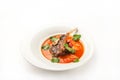 Vegetable soup with tomatoes in a restaurant close-up. Lamb soup on bone noodles on a white plate and copy space Royalty Free Stock Photo