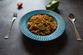 Vegetable spiral pasta served in a blue bowl. Close up.