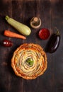 Vegetable Spiral tart with zucchini, eggplant, carrot on wooden background