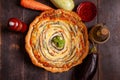 Vegetable Spiral tart with zucchini, eggplant, carrot on wooden background