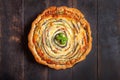 Vegetable Spiral tart with zucchini, eggplant, carrot on wooden background