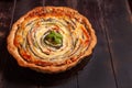 Vegetable Spiral tart with zucchini, eggplant, carrot on wooden background