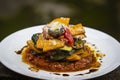 Vegetable stack - pumpkin, zucchini, red capsicum, eggplant and mushroom cooked in a tomato, onion, and garlic sauce topped with p