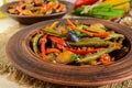 Vegetable stew salad: bell pepper, eggplant, asparagus beans, garlic, carrot, leek. Bright spicy aromatic dishes. Royalty Free Stock Photo