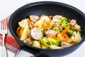 Vegetable stew with sausage grilled slices in a frying pan on a Royalty Free Stock Photo