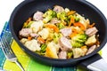 Vegetable stew with sausage grilled slices in a frying pan on a Royalty Free Stock Photo