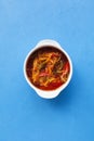 Vegetable stew in a spicy tomato sauce. Blue background, copy space, top view Royalty Free Stock Photo