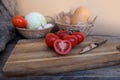 vegetable stocks are laid out on wooden shelf, ripe red tomatoes, head of cabbage in basket, garlic, pumpkin, onions, old dishes,