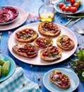 Sweet potato toast with beet hummus, grilled chickpeas, fresh parsley, nigella seeds and sunflower seeds on a plate on a table Royalty Free Stock Photo
