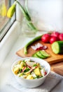 Vegetable vitamin salad with egg, fresh radish cucumber and green onions on a background of chopped vegetables Royalty Free Stock Photo