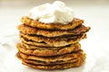 Vegetable Zucchini fritters stack served sour cream on on white plate close up Royalty Free Stock Photo