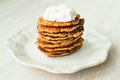 Vegetable Zucchini fritters stack served sour cream on on white plate close up Royalty Free Stock Photo