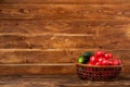 Vegetables in a basket on a brown wooden background