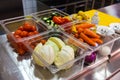 Vegetables - carrots, onions, cabbage, tomatoes, red peppers, cucumbers - in plastic containers in the kitchen Royalty Free Stock Photo