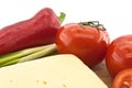 Vegetables and cheese on cutting board, on white background Royalty Free Stock Photo