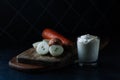 Vegetables before cooking, onions, carrots and sour cream on a cutting wooden board. low key. close-up. food concept Royalty Free Stock Photo