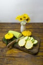 Vegetables are cut with a knife on a dark wooden board. Squash and squash, ingredients for a mono diet. Healthy food concept, eco