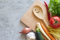 Vegetables, cutting board and smiling spoon on concrete background. Healthy eating Royalty Free Stock Photo