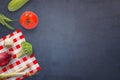 Vegetables on dark kichen table. Zucchini, tomato, chocolate, broccoli, onion, onion, broccoli and table cloth on table Royalty Free Stock Photo