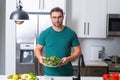 Vegetables diet. Young woman eating healthy food, dieting. Guy eating vegetable diet salad in studio. Vegan salad. Male Royalty Free Stock Photo