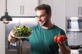 Vegetables diet. Young woman eating healthy food, dieting. Guy eating vegetable diet salad in studio. Vegan salad. Male Royalty Free Stock Photo