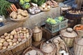 Vegetables and drinks for sell in vintage street market. Potatoes, carrots,green cauliflower,garlic, onions and cabbage in baskets Royalty Free Stock Photo