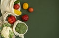 Vegetables in eco bag on green surface with a copy space. Pepper, tomato, corn, cucumber, broccoli, cauliflower in Royalty Free Stock Photo