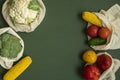 Vegetables in eco bag on green surface with a copy space. Pepper, tomato, corn, cucumber, broccoli, cauliflower in Royalty Free Stock Photo