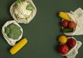 Vegetables in eco bag on green surface with a copy space. Pepper, tomato, corn, cucumber, broccoli, cauliflower in Royalty Free Stock Photo