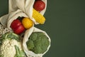 Vegetables in eco bag on green surface with a copy space. Pepper, tomato, corn, cucumber, broccoli, cauliflower in Royalty Free Stock Photo