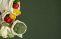 Vegetables in eco bag on green surface with a copy space. Pepper, tomato, corn, cucumber, broccoli, cauliflower in Royalty Free Stock Photo