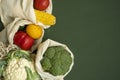 Vegetables in eco bag on green surface with a copy space. Pepper, tomato, corn, cucumber, broccoli, cauliflower in Royalty Free Stock Photo