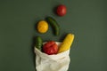 Vegetables in eco bag on green surface. Pepper, tomato, corn, cucumber, broccoli, cauliflower in reusable shopping eco Royalty Free Stock Photo