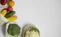 Vegetables in eco bag on white surface with a copy space. Pepper, tomato, corn, cucumber, broccoli, cauliflower in Royalty Free Stock Photo