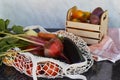 Vegetables in eco shopping reusable bag and wooden box tomatoes, purple potatoes, eggplants, carrots, sweet pepper Royalty Free Stock Photo